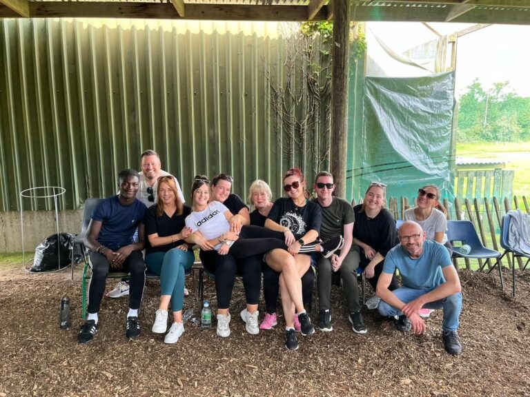 SMC team members relaxing together outdoors